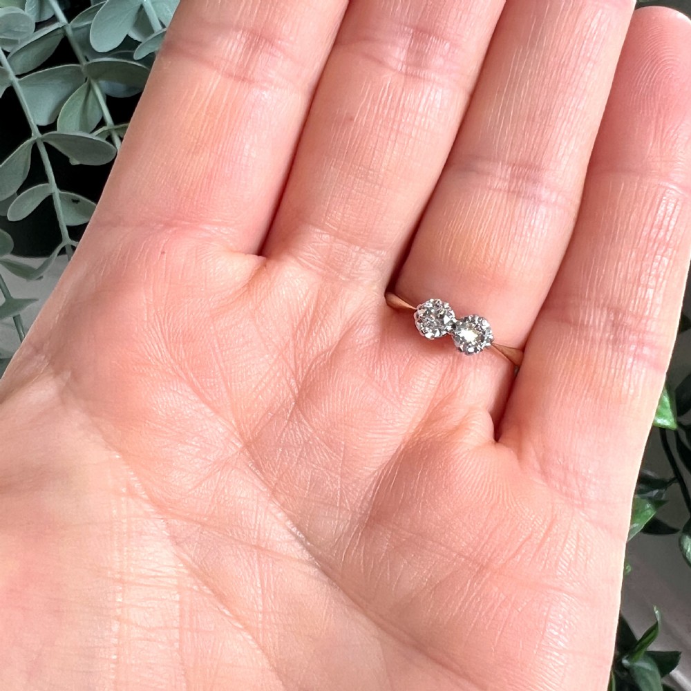 A vintage Toi et Moi ring featuring two round diamonds in platinum settings on an 18ct yellow gold band. View VII
