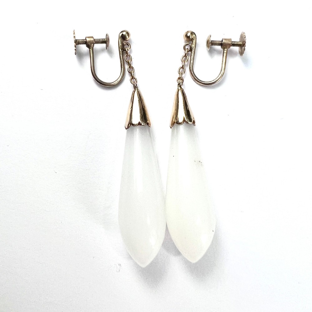 A pair of antique 9ct gold drop earrings featuring smooth, teardrop-shaped white chalcedony stones suspended on short chains from screw-back fastenings. View II
