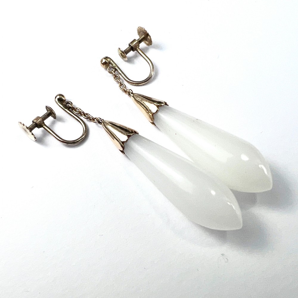 A pair of antique 9ct gold drop earrings featuring smooth, teardrop-shaped white chalcedony stones suspended on short chains from screw-back fastenings. View III