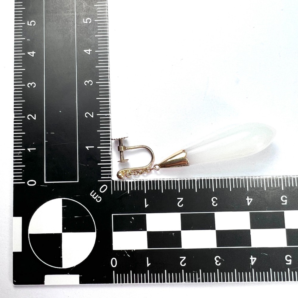 A pair of antique 9ct gold drop earrings featuring smooth, teardrop-shaped white chalcedony stones suspended on short chains from screw-back fastenings. View VII