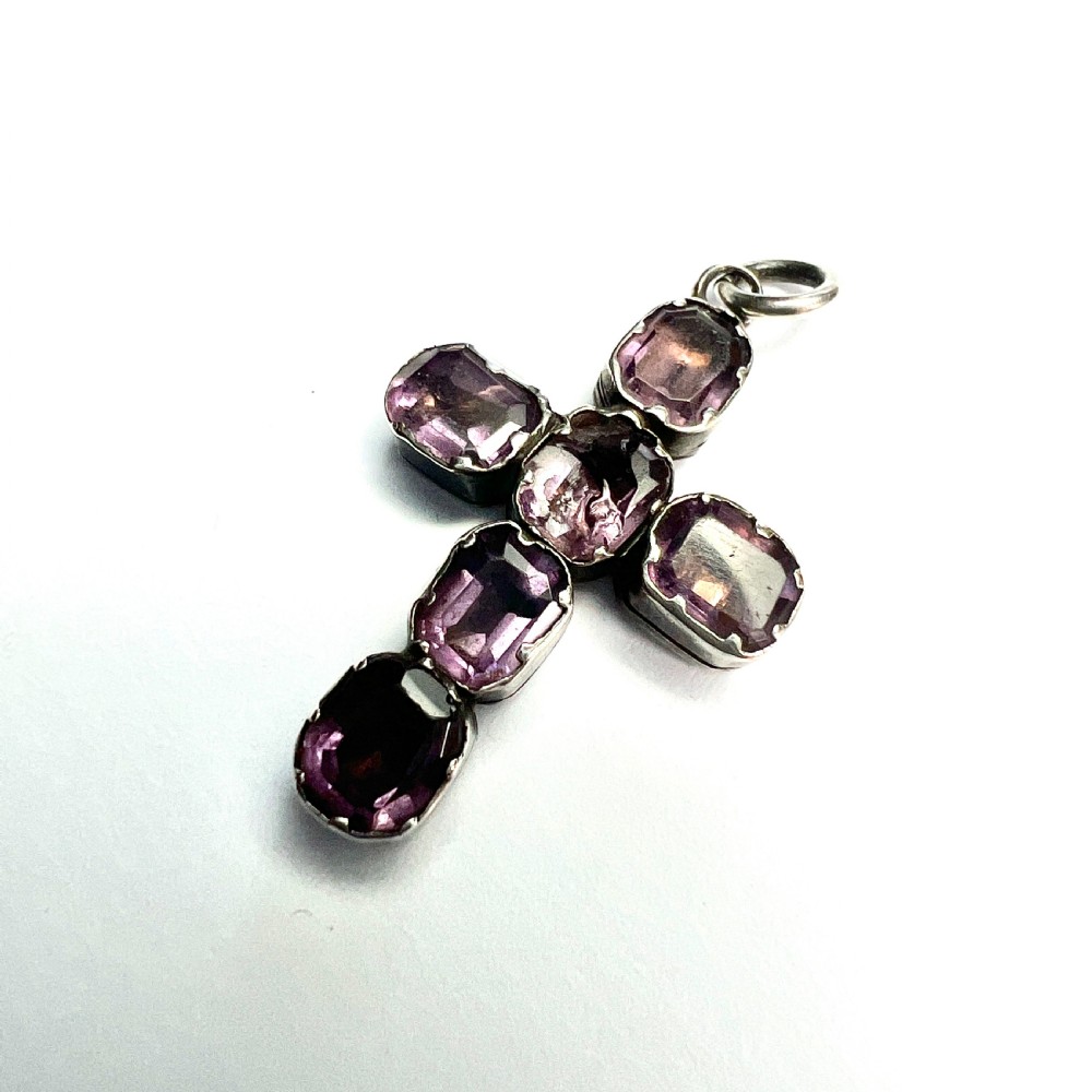 A Georgian silver cross pendant set with six foil-backed faceted purple amethyst gemstones in crimped collet settings. View II