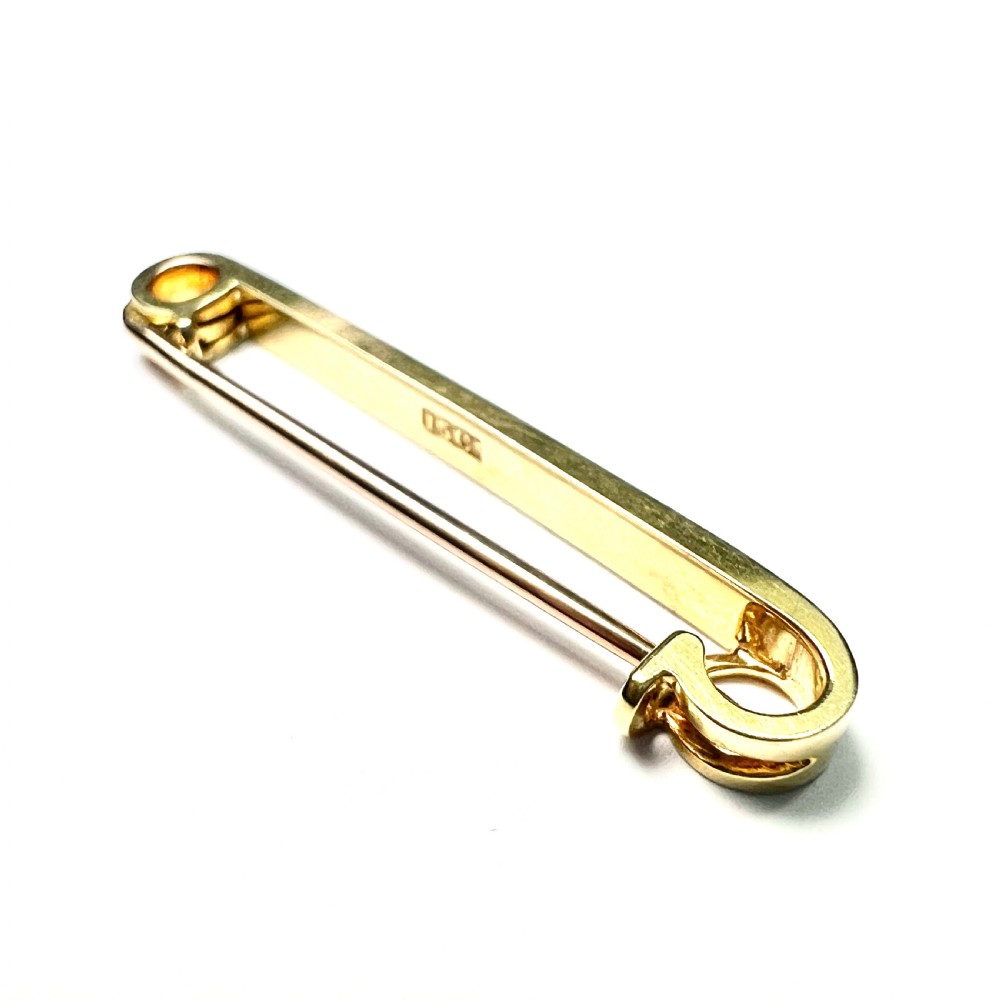 An antique 15ct yellow gold bar brooch designed as a safety pin, set with a row of seed pearls framed by black enamel detailing. View III