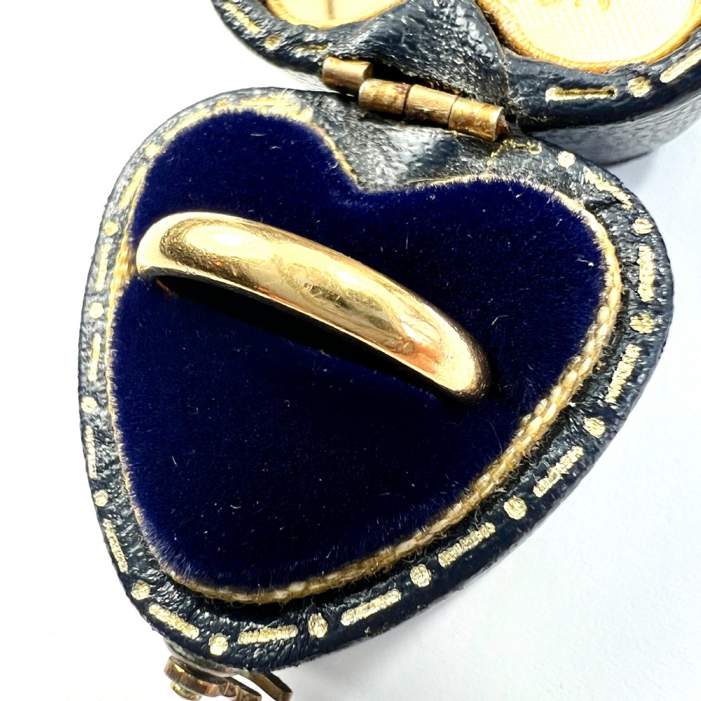 A polished 22ct yellow gold wedding band featuring a smooth, rounded profile. View II