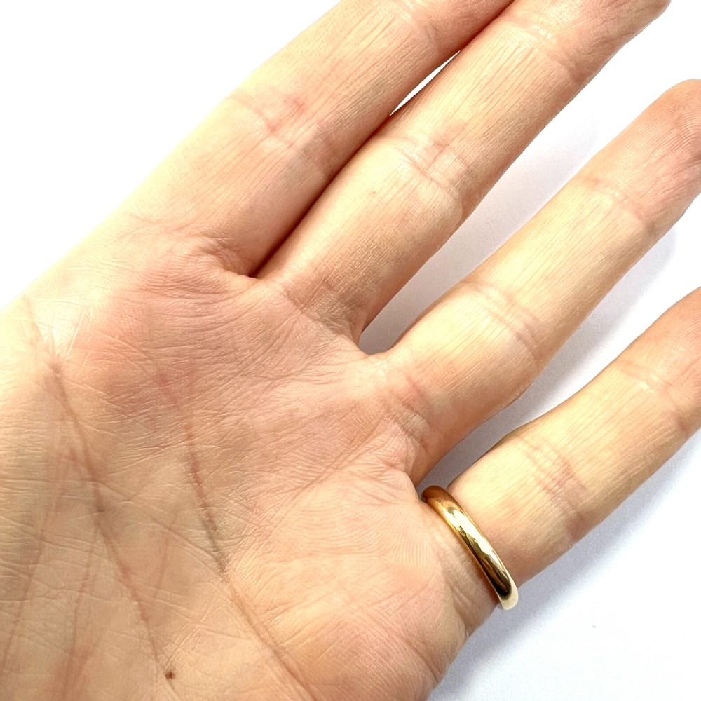 A polished 22ct yellow gold wedding band featuring a smooth, rounded profile. View III