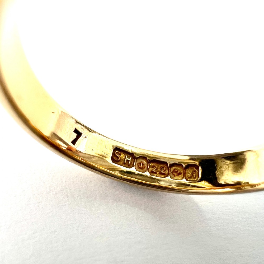 A polished 22ct yellow gold wedding band featuring a smooth, rounded profile. View VII