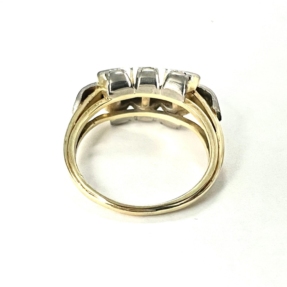 A vintage diamond engagement ring featuring three square-set diamonds in platinum and 14ct gold with geometric openwork detailing. View VI