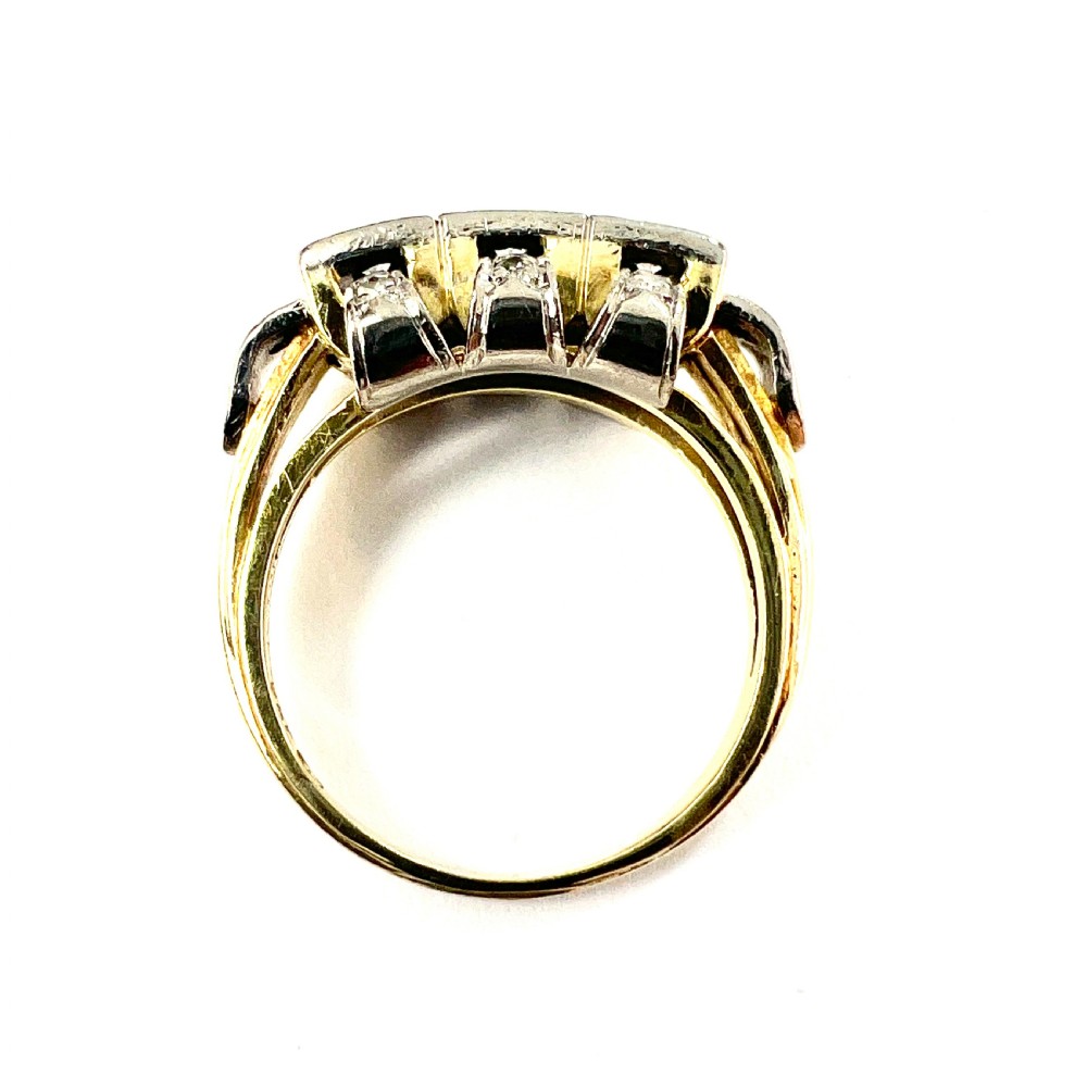 A vintage diamond engagement ring featuring three square-set diamonds in platinum and 14ct gold with geometric openwork detailing. View VIII