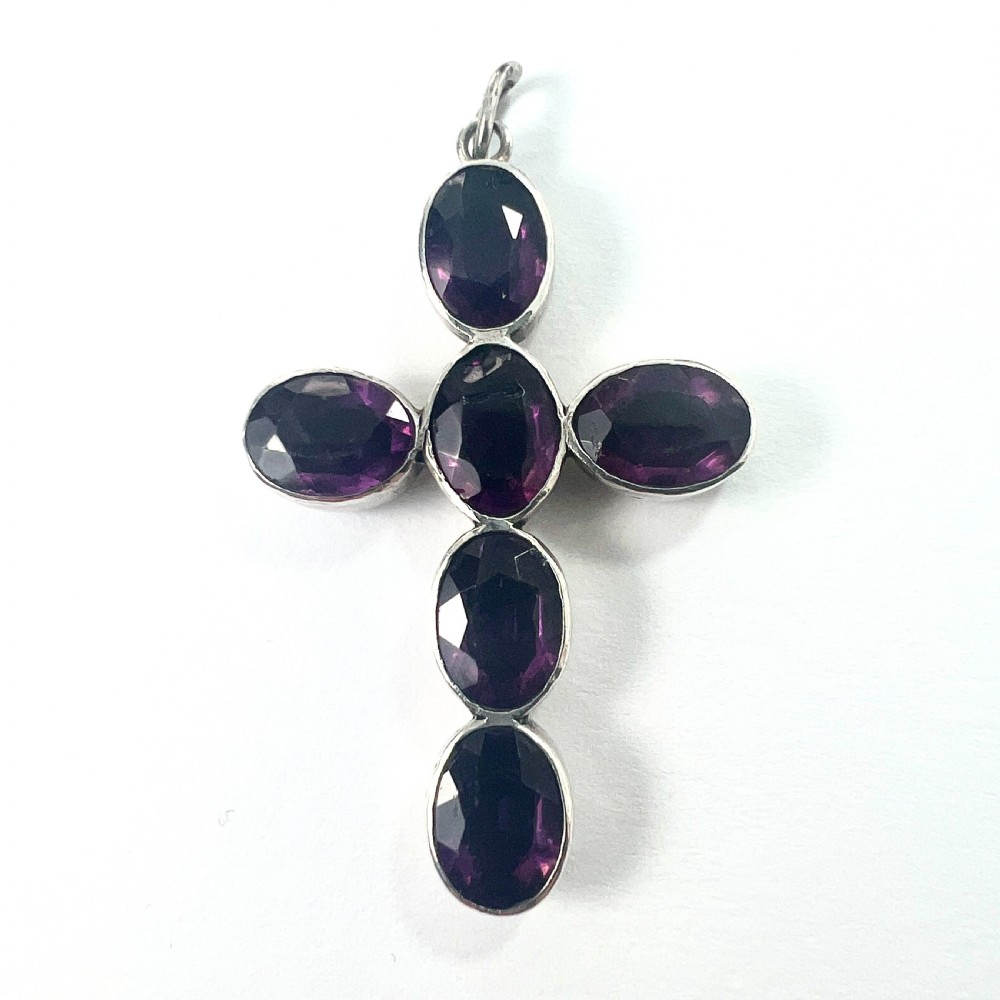 A Georgian silver cross pendant set with six oval faceted purple paste stones in closed collet mounts. View II