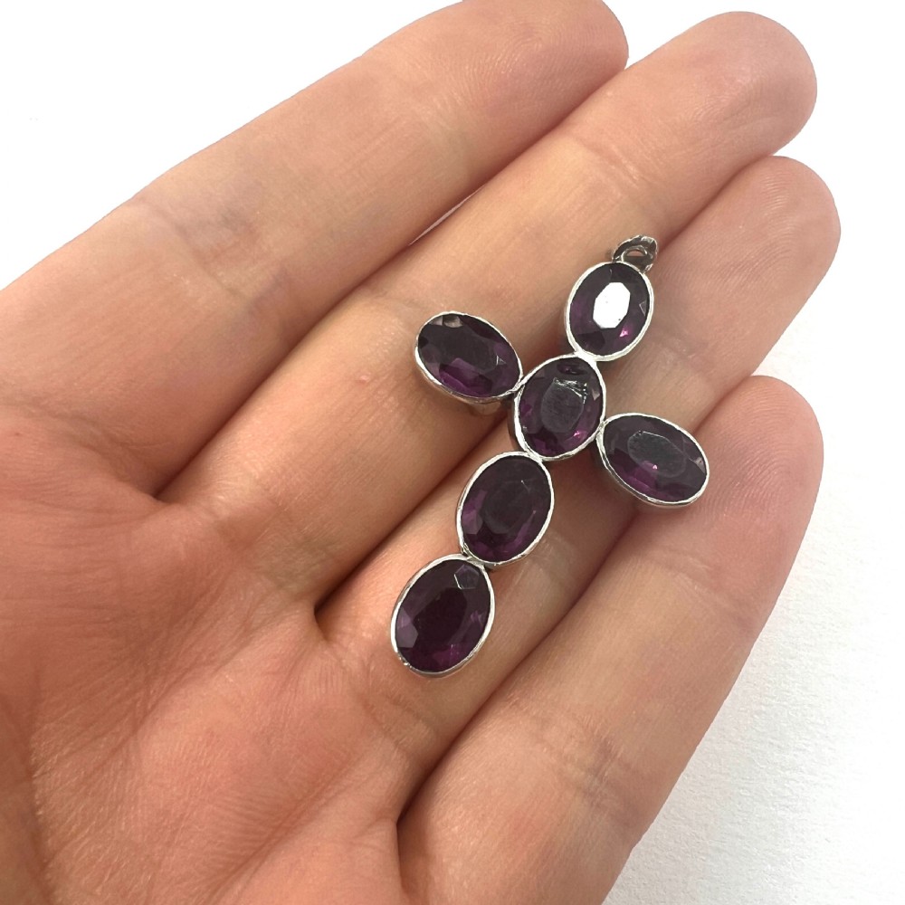 A Georgian silver cross pendant set with six oval faceted purple paste stones in closed collet mounts. View IV