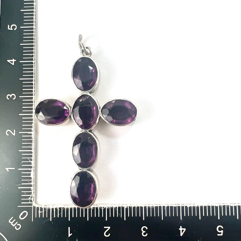 A Georgian silver cross pendant set with six oval faceted purple paste stones in closed collet mounts. View VIII