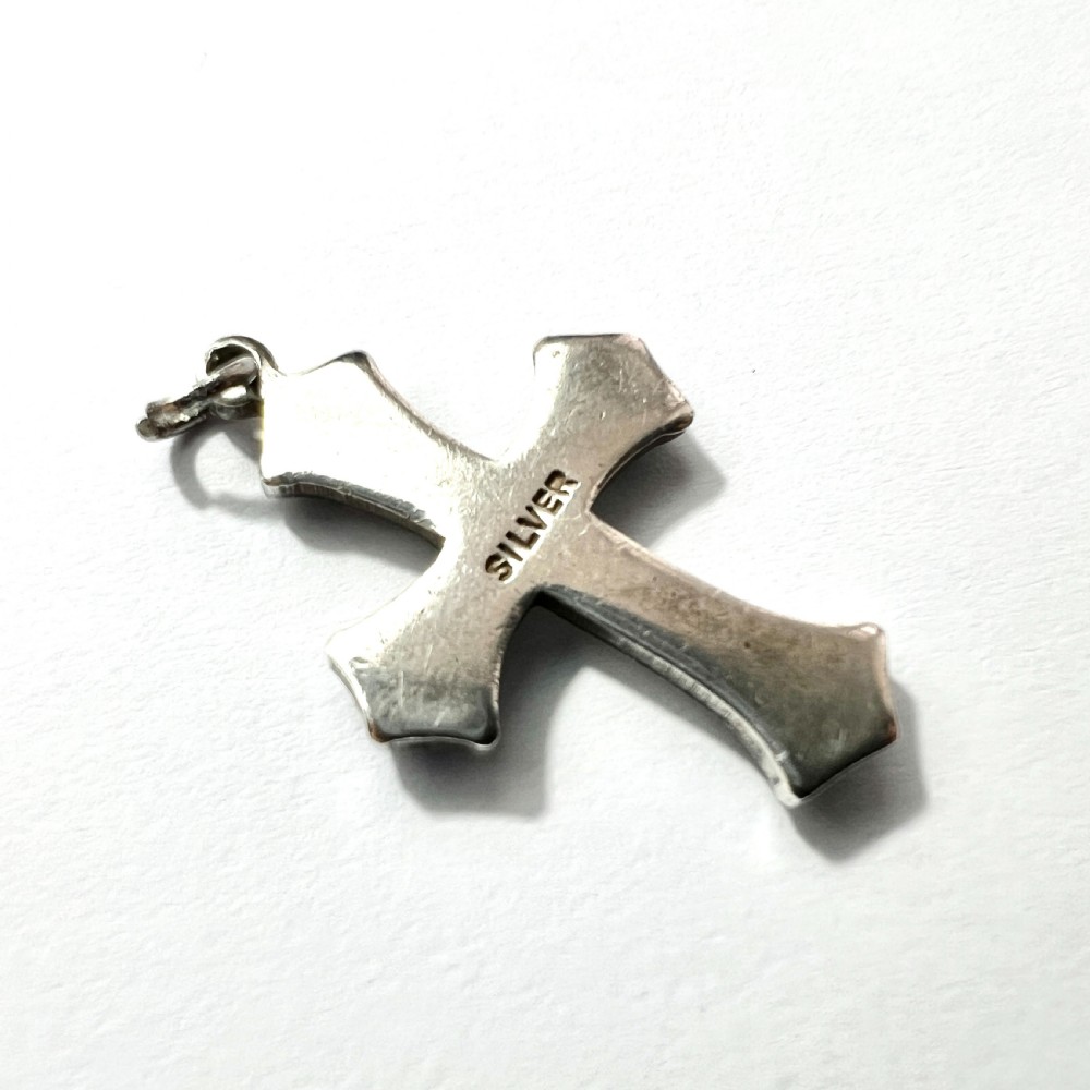 An antique sterling silver cross pendant set with blue paste cabochons and central white pearls against a white background. View IV