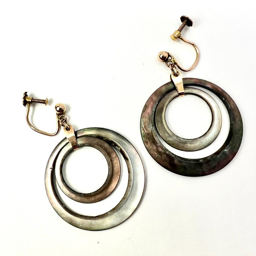 Pair of Art Deco 9ct gold screwback drop earrings featuring concentric mother of pearl hoop pendants. View II