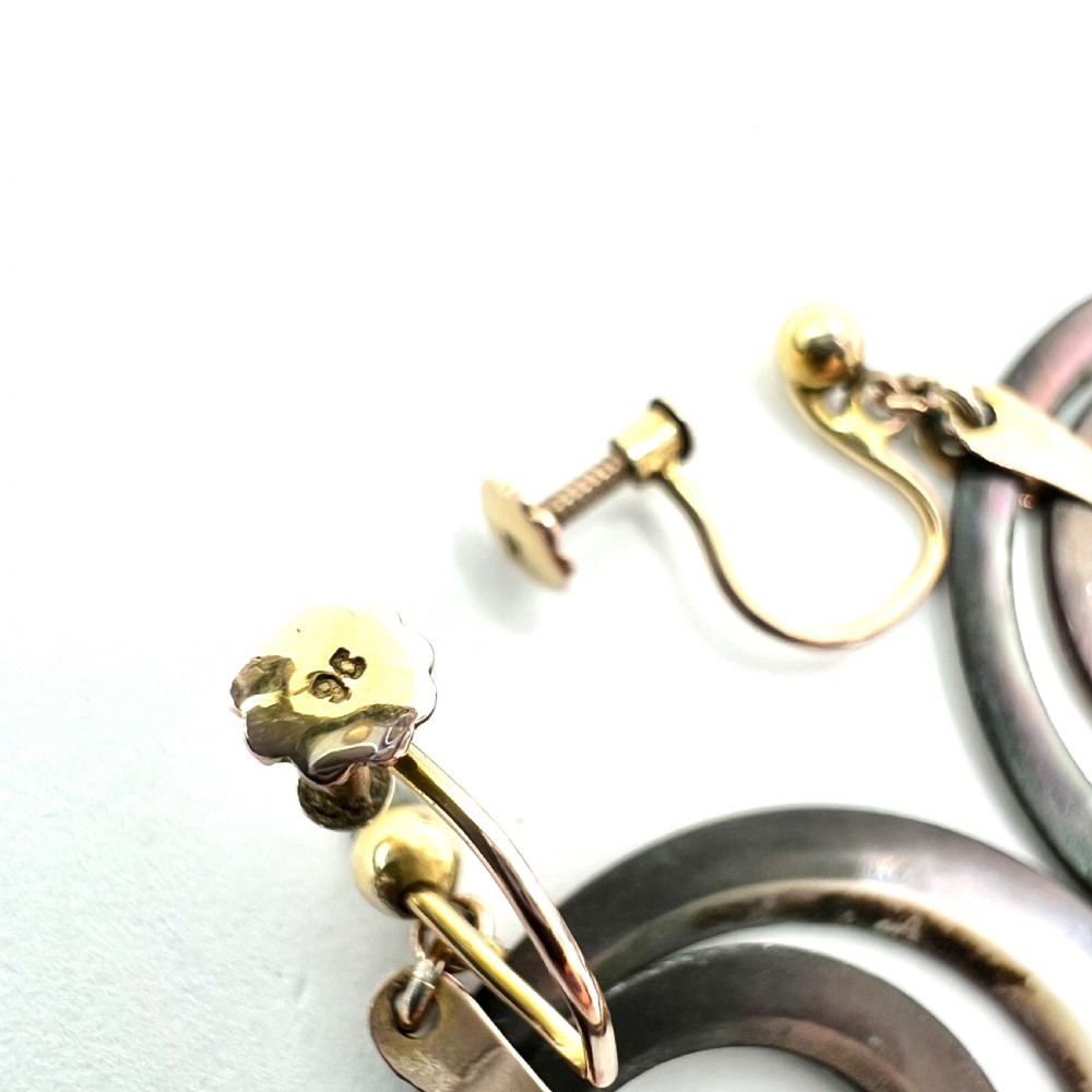 Pair of Art Deco 9ct gold screwback drop earrings featuring concentric mother of pearl hoop pendants. View III
