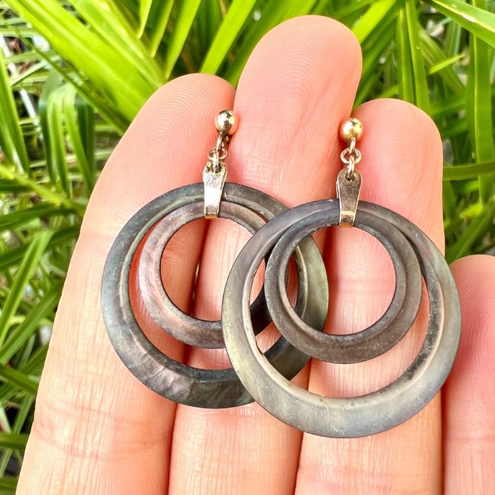 Pair of Art Deco 9ct gold screwback drop earrings featuring concentric mother of pearl hoop pendants. View IV
