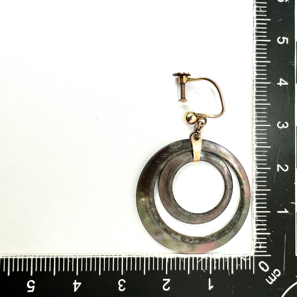 Pair of Art Deco 9ct gold screwback drop earrings featuring concentric mother of pearl hoop pendants. View V