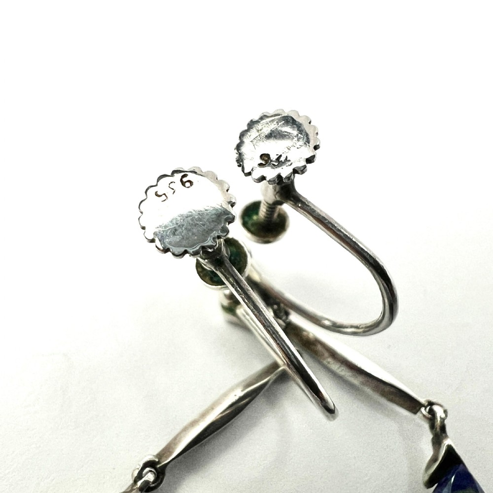 A pair of Art Deco silver screwback drop earrings featuring faceted blue teardrop stones suspended from linear marcasite-set bars. View III