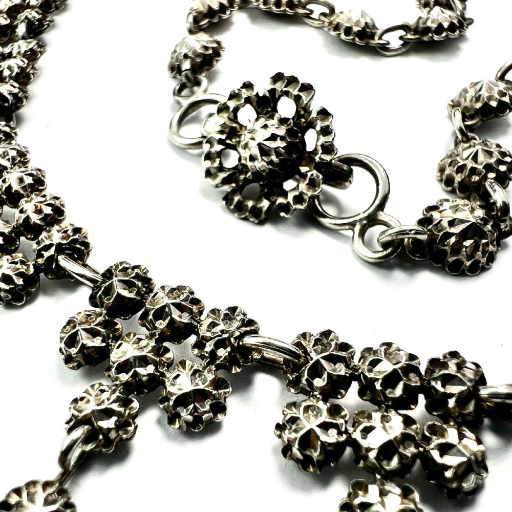 Victorian sterling silver necklace featuring textured spherical links and suspended chandelier drop motifs against a white backdrop. View V