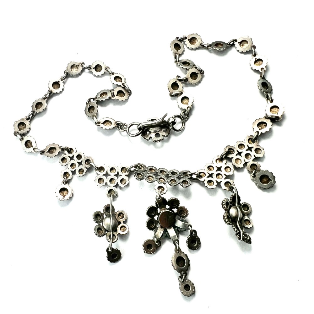 Victorian sterling silver necklace featuring textured spherical links and suspended chandelier drop motifs against a white backdrop. View VI