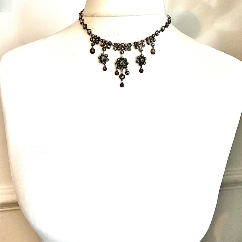 Victorian sterling silver necklace featuring textured spherical links and suspended chandelier drop motifs against a white backdrop. View IX