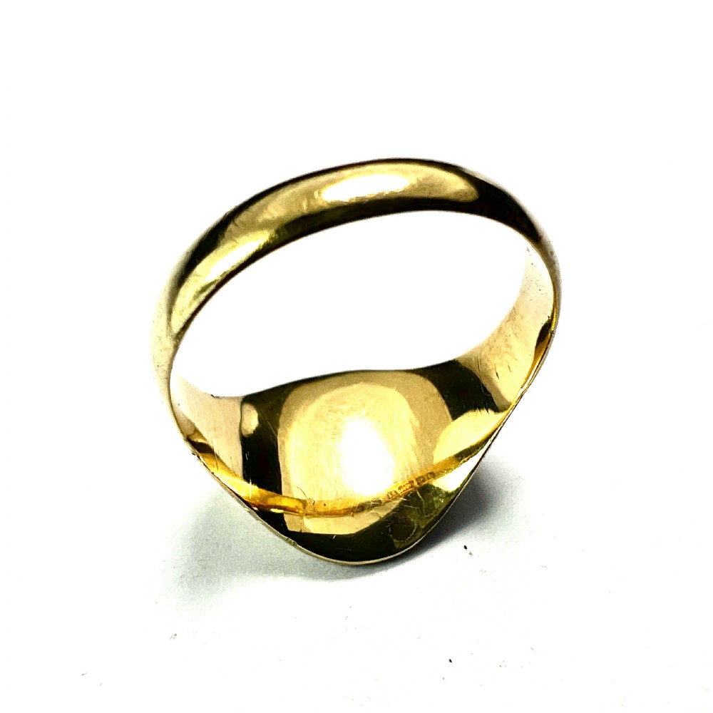 An antique yellow gold signet ring featuring an oval head with a hand-engraved monogram and detailed heart motifs on the shoulders. View III