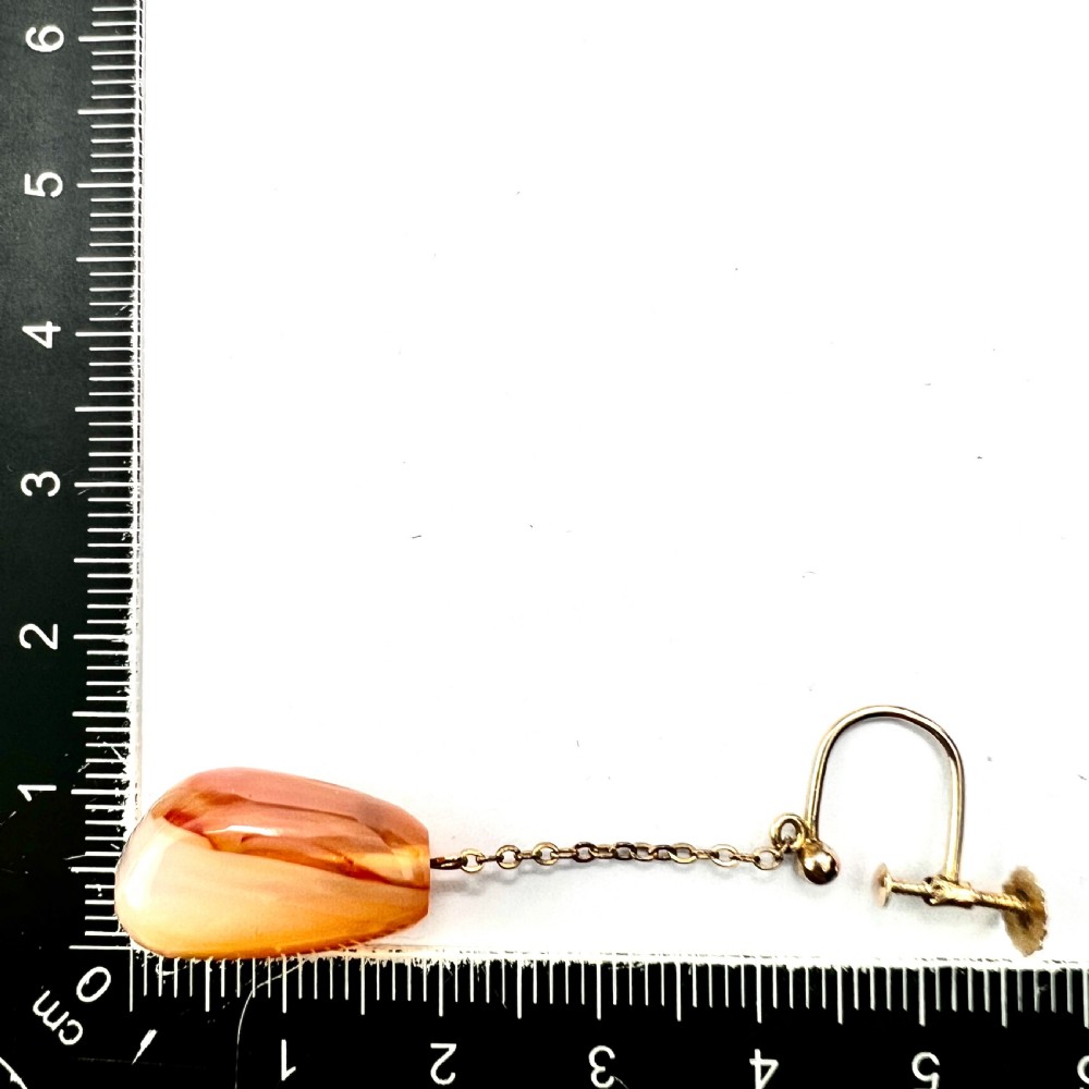 A pair of antique nine-carat gold screwback earrings featuring fine chain links suspending polished orange-toned agate teardrops. View VIII