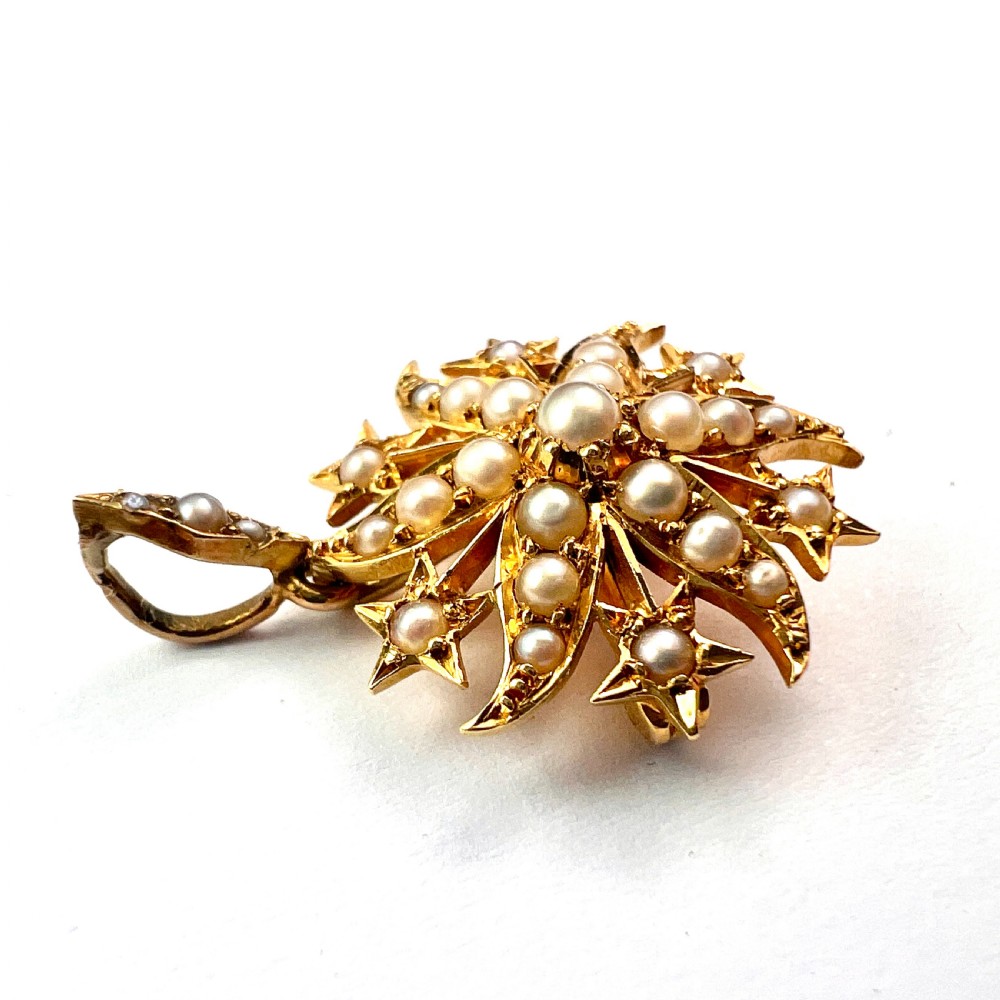 An antique 18ct yellow gold sunburst pendant brooch embellished with central and accent pearls arranged in a celestial motif with an attached pearl-set bale. View III