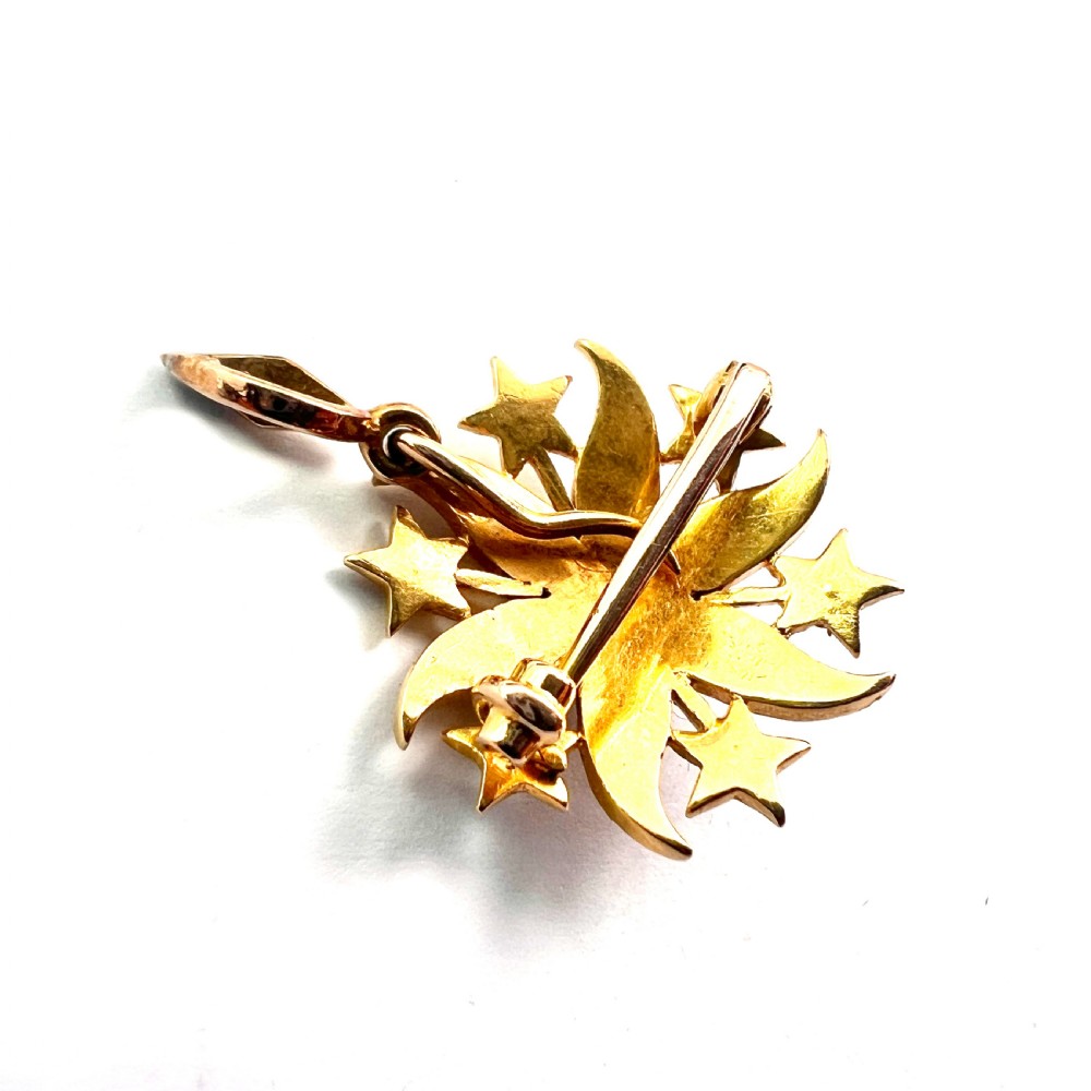 An antique 18ct yellow gold sunburst pendant brooch embellished with central and accent pearls arranged in a celestial motif with an attached pearl-set bale. View VII