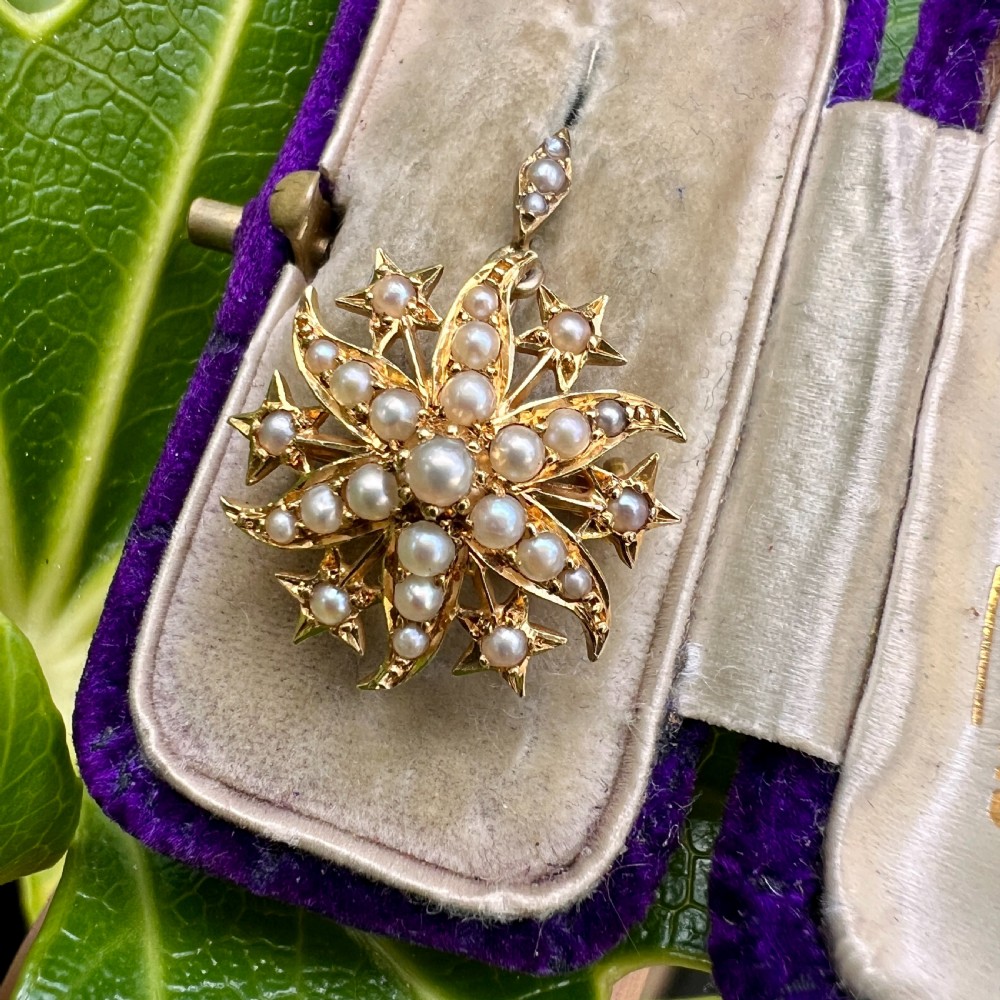 An antique 18ct yellow gold sunburst pendant brooch embellished with central and accent pearls arranged in a celestial motif with an attached pearl-set bale. View VIII