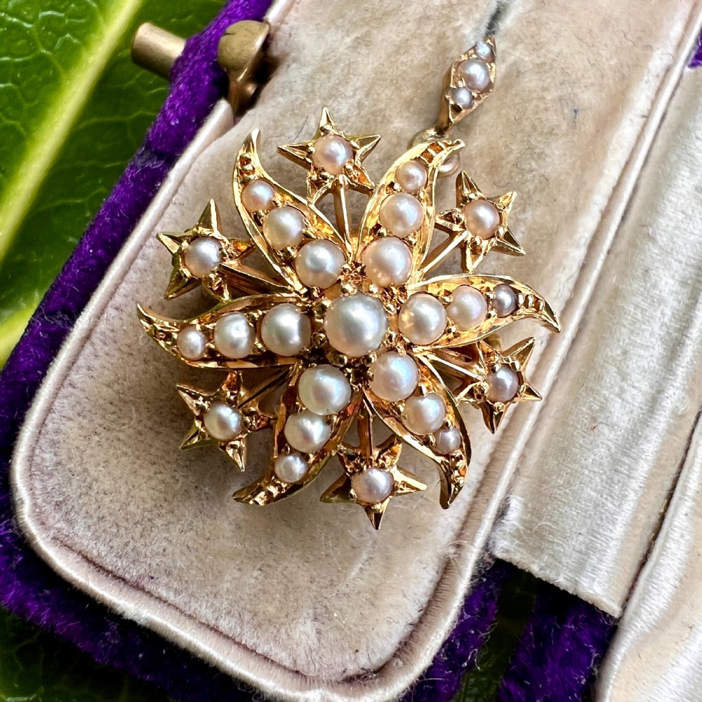 An antique 18ct yellow gold sunburst pendant brooch embellished with central and accent pearls arranged in a celestial motif with an attached pearl-set bale. View IX