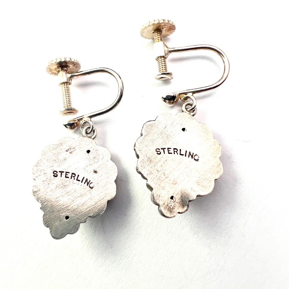 A pair of silver Victorian Aesthetic Era drop earrings featuring a sunburst motif with beaded detailing and screwback fastenings. View III
