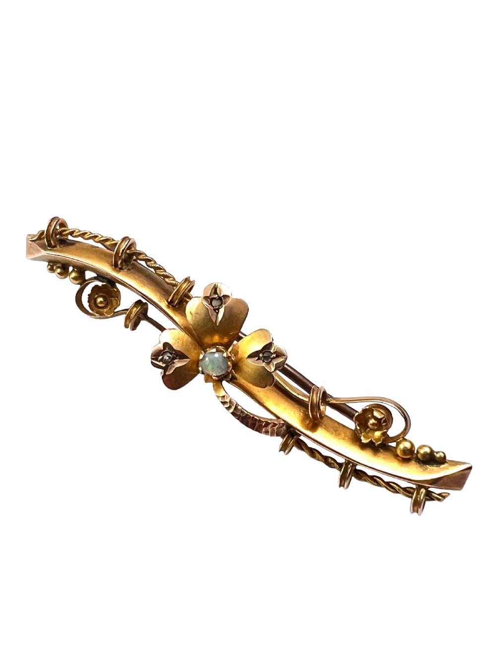 A Victorian 9ct yellow gold bar brooch featuring a central three-leaf clover set with a cabochon opal and accent diamonds. View II