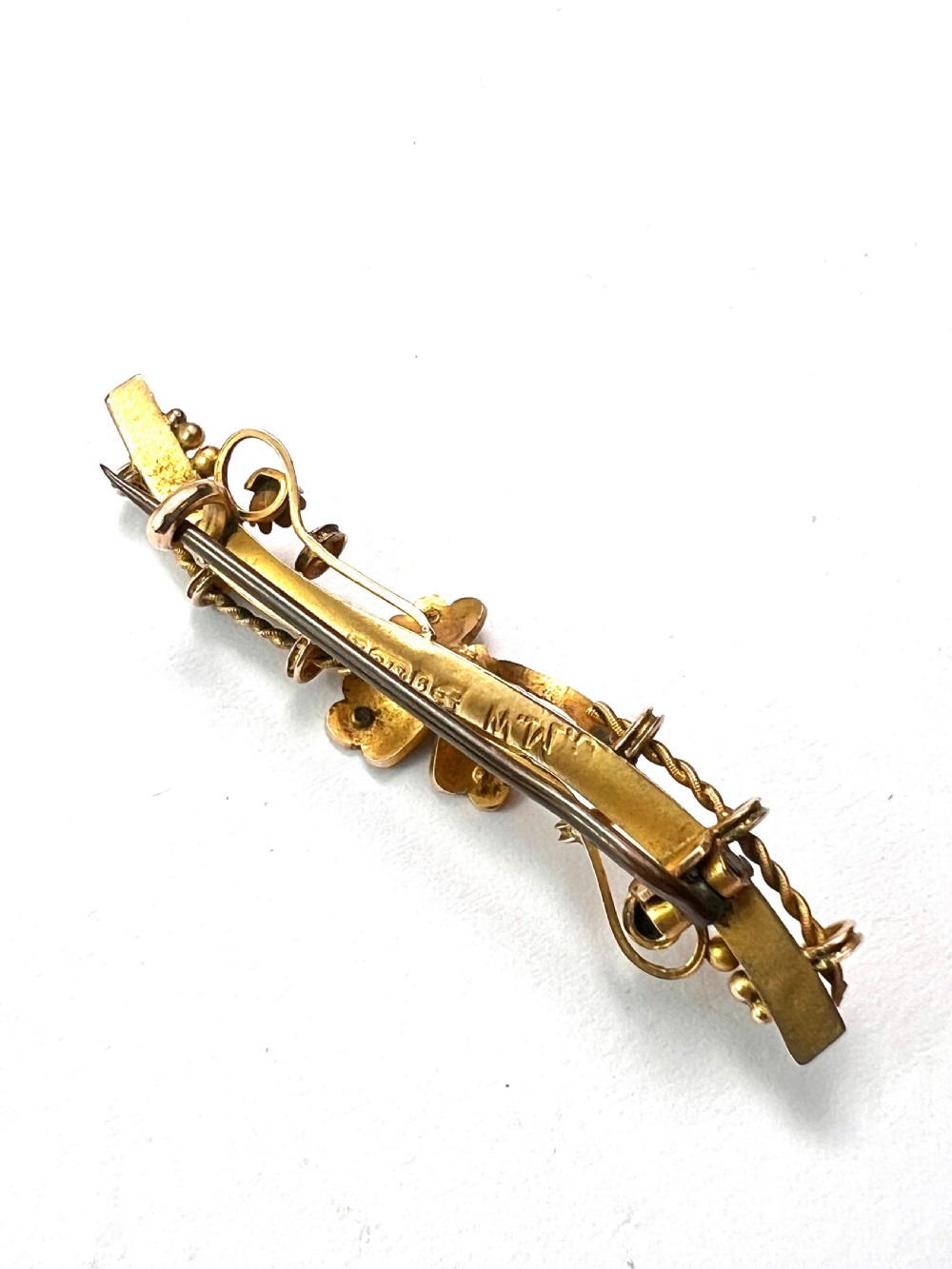 A Victorian 9ct yellow gold bar brooch featuring a central three-leaf clover set with a cabochon opal and accent diamonds. View III