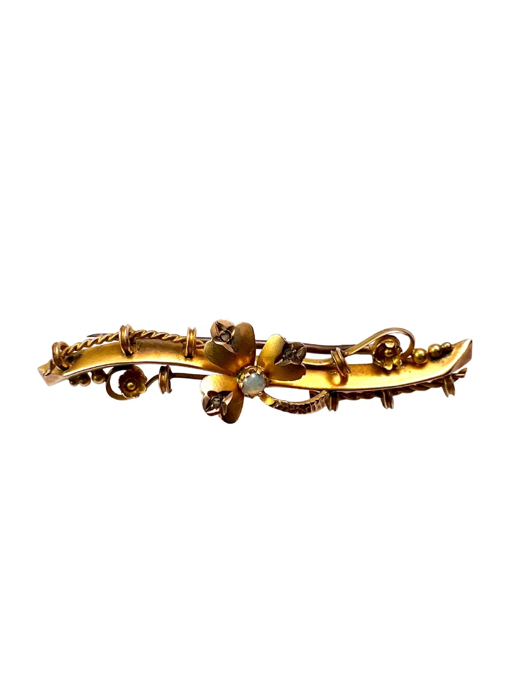 A Victorian 9ct yellow gold bar brooch featuring a central three-leaf clover set with a cabochon opal and accent diamonds. View VI