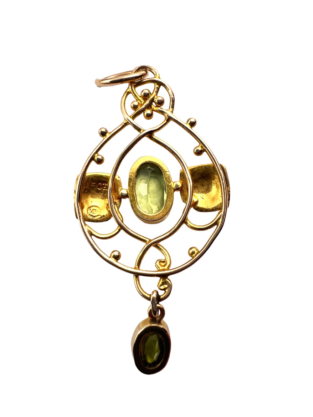 An Edwardian 15ct gold Art Nouveau openwork pendant set with two faceted green peridot gemstones. View IV