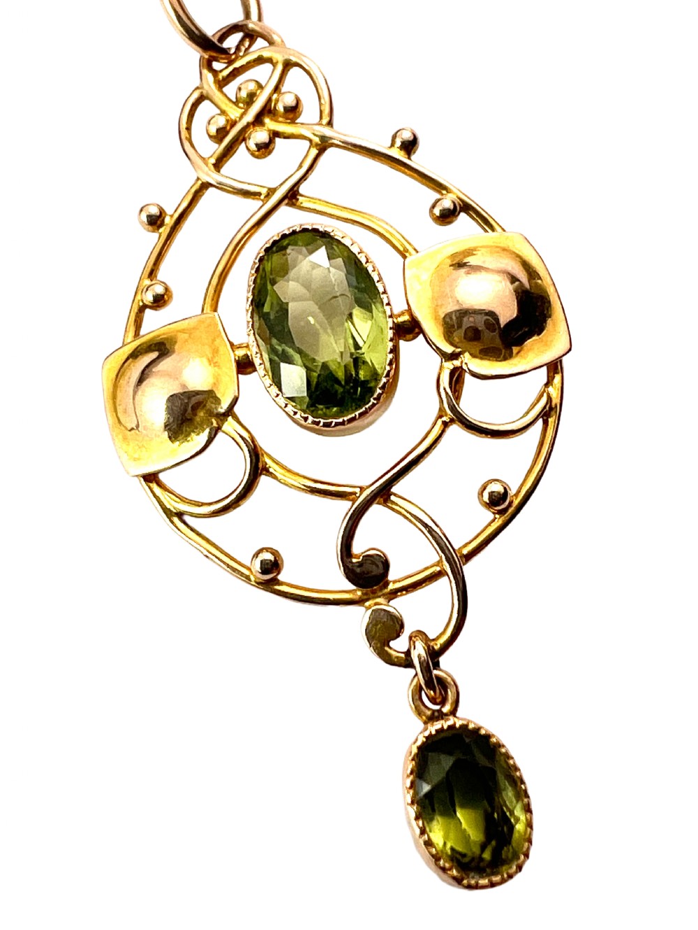 An Edwardian 15ct gold Art Nouveau openwork pendant set with two faceted green peridot gemstones. View VI