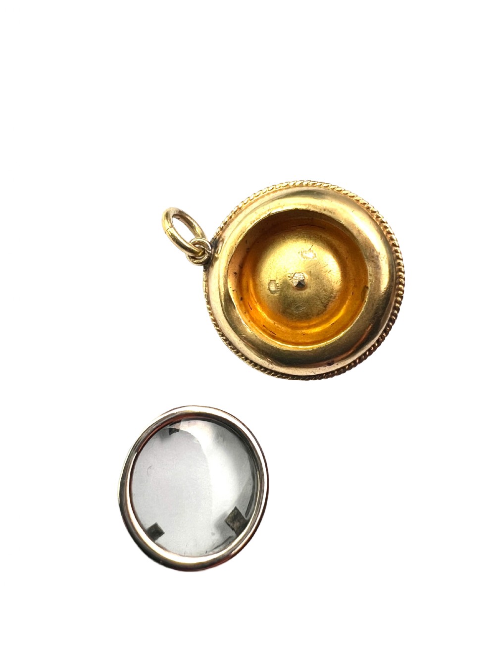A circular Victorian yellow gold pendant featuring a large central pearl bordered by intricate filigree wirework and ropework detail. View V