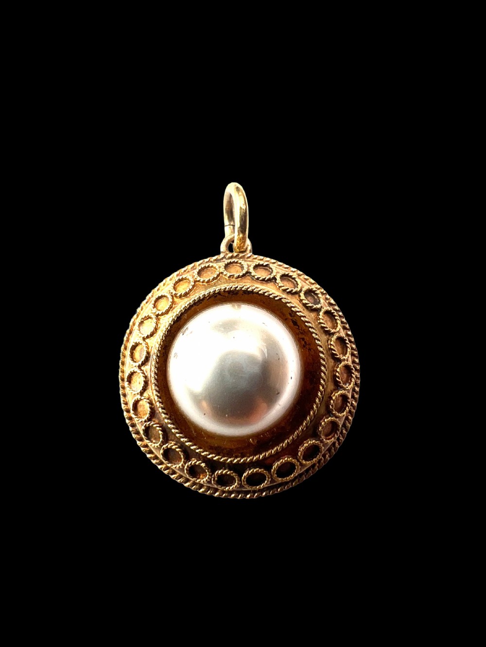 A circular Victorian yellow gold pendant featuring a large central pearl bordered by intricate filigree wirework and ropework detail. View VII