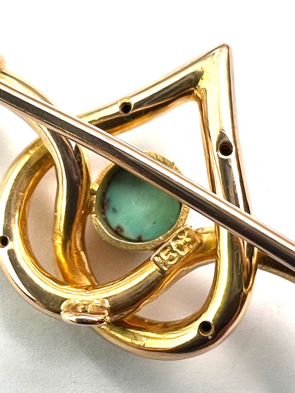 An antique 15ct yellow gold bar brooch featuring a central entwined heart motif set with a round turquoise cabochon stone. View VII