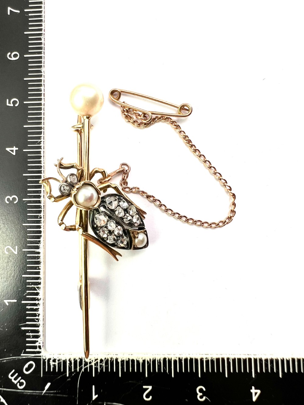 Victorian gold beetle brooch set with pave diamonds on the wing cases and pearls on the body and pin, fitted with a safety chain. View V