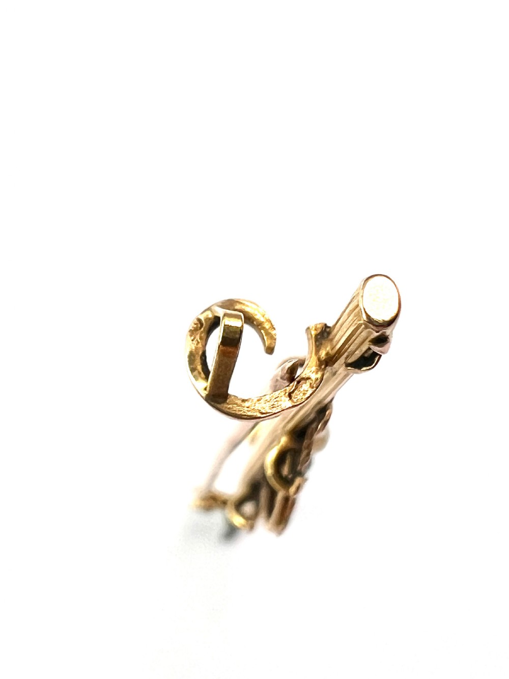 An antique 18-carat yellow gold bar brooch featuring a central circular motif with a round red garnet flanked by seed pearls and fluted bar details. View VIII