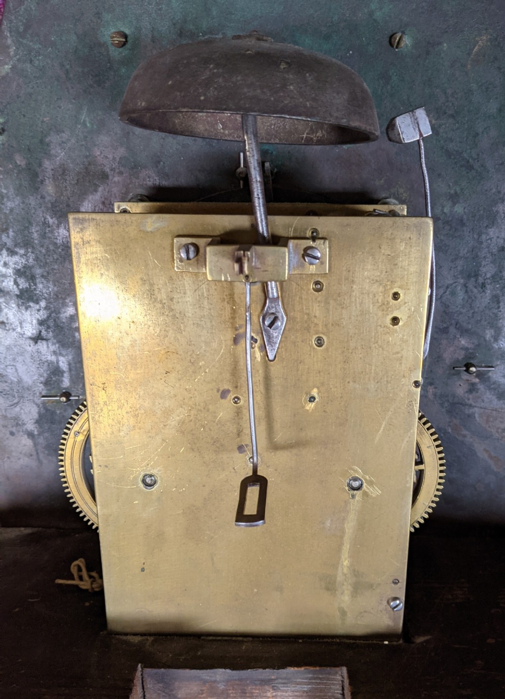 An early 18th-century brass longcase clock dial featuring an arched top with cherub spandrels, a central engraved sun face, and a silvered chapter ring with Roman numerals signed W. Reynolds Uxbridge. View III