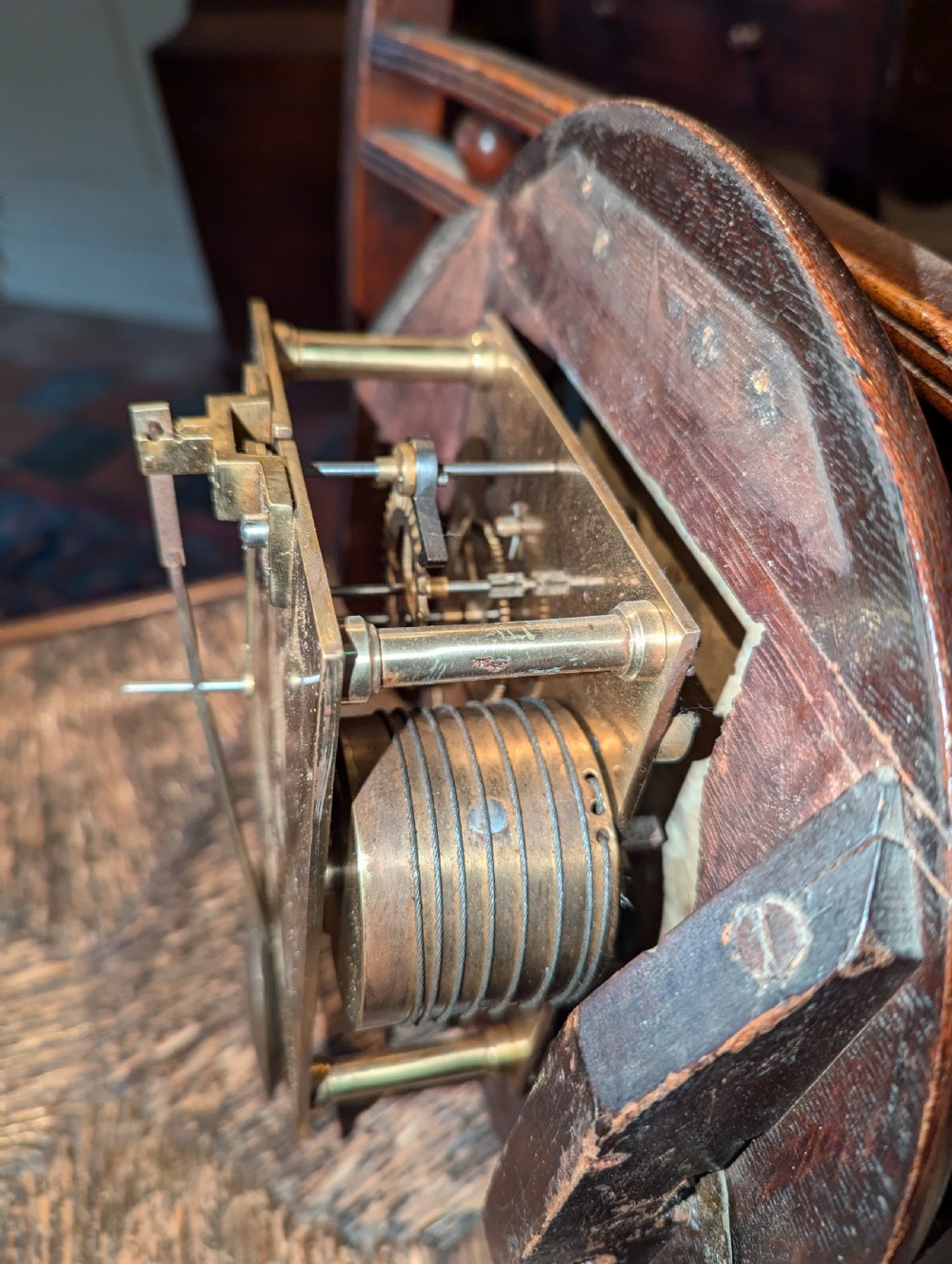 A late nineteenth-century circular oak fusee dial clock with a brass bezel and Roman numerals. View IV