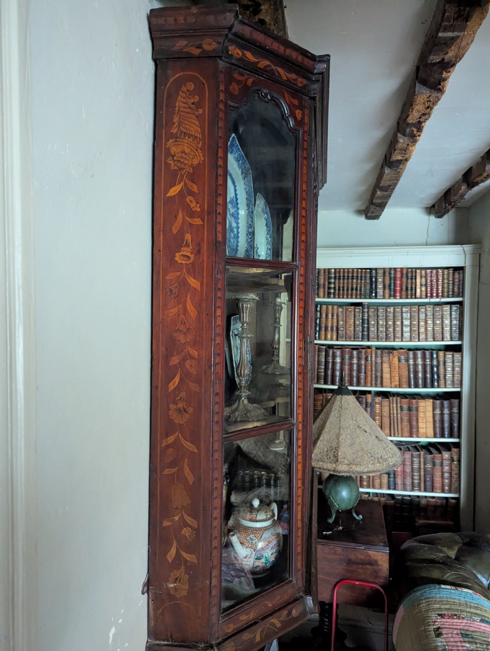 A 19th-century Dutch wall-mounted display cabinet crafted from dark wood with detailed floral marquetry inlay and multi-pane glazed doors. View IV