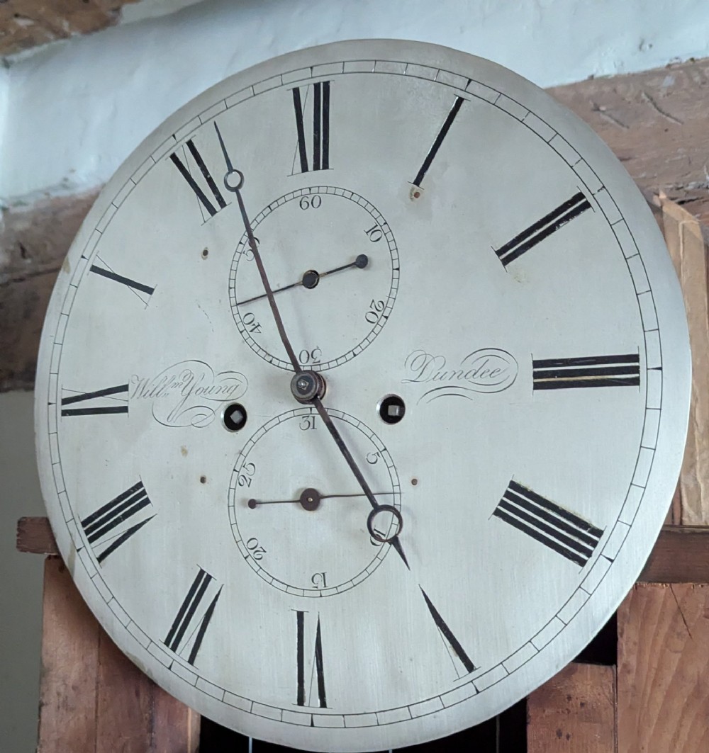 A 19th-century flame mahogany longcase regulator clock with an arched pediment, round silvered dial, and panelled wooden trunk. View VIII