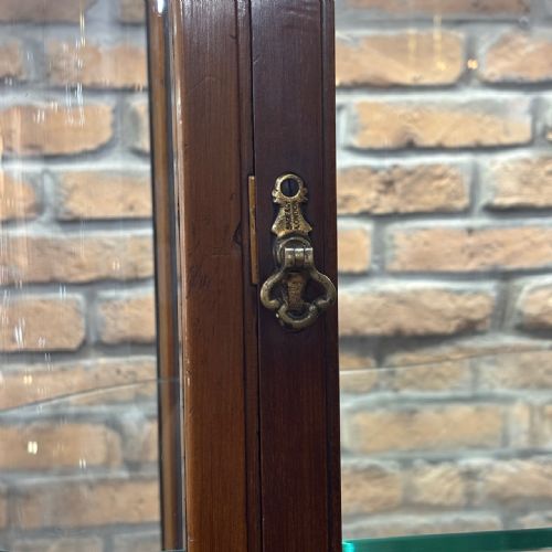 fig 2. An Edwardian mahogany and curved glass shop display cabinet featuring tiered glass shelves and a parquet inlaid timber base.