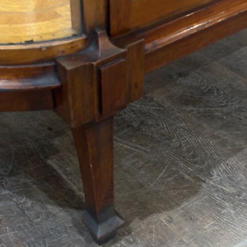 fig 3. An Edwardian mahogany and curved glass shop display cabinet featuring tiered glass shelves and a parquet inlaid timber base.