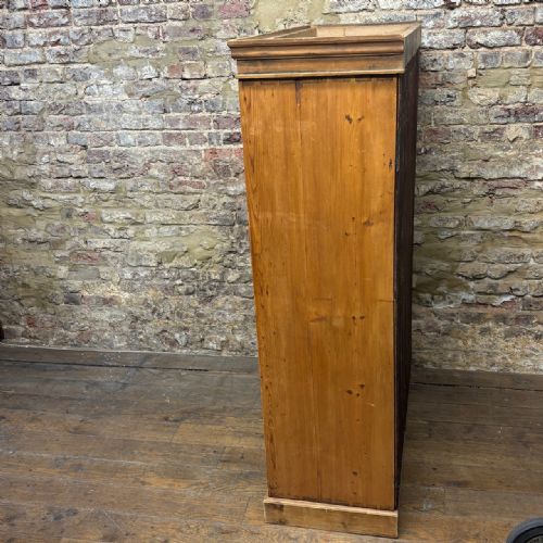fig 1. A tall antique pine locker cabinet featuring fifteen panelled door compartments arranged in three columns with metal latches.