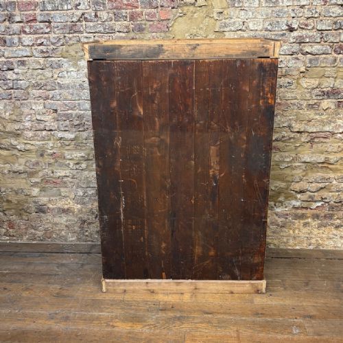 fig 2. A tall antique pine locker cabinet featuring fifteen panelled door compartments arranged in three columns with metal latches.