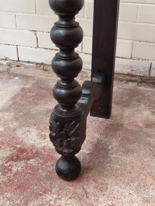 fig 2. Dark carved oak hall table featuring a carved floral gallery, relief apron, bobbin-turned front legs, and lower stretcher.