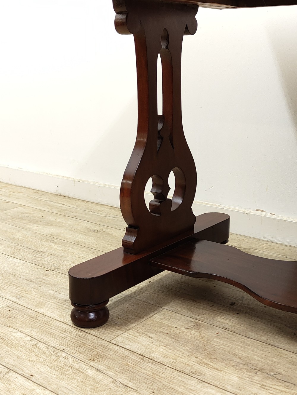 A Victorian mahogany washstand with a rectangular white marble top resting on twin pierced trestle supports linked by a shaped stretcher. View XIII